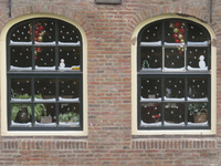 906724 Afbeelding van twee ramen met kerstversiering van pannenkoekenrestaurant De Oude Muntkelder (Oudegracht aan de ...